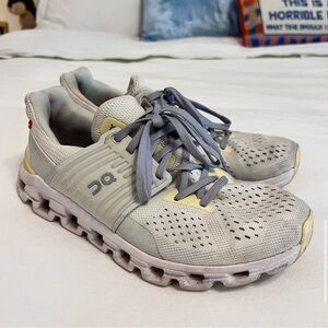 White, Grey, and Yellow On CloudSwift Sneakers